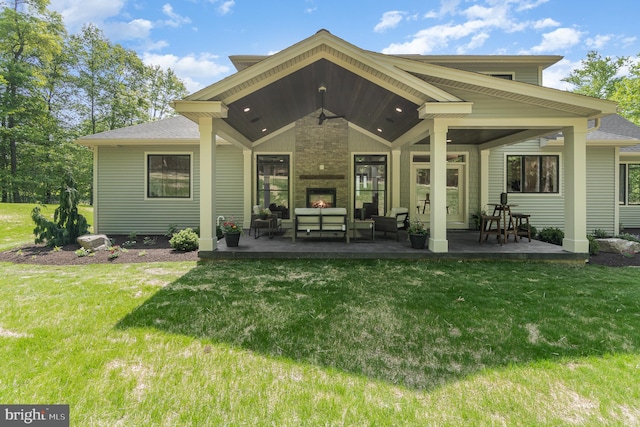 rear view of property with a patio and a lawn