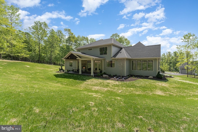 rear view of property with a yard