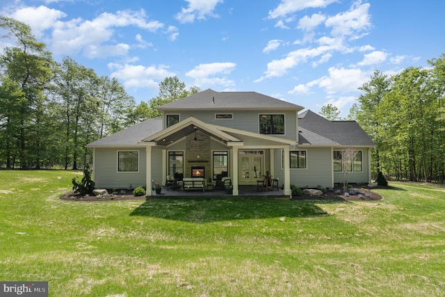 rear view of house featuring a yard and a patio area