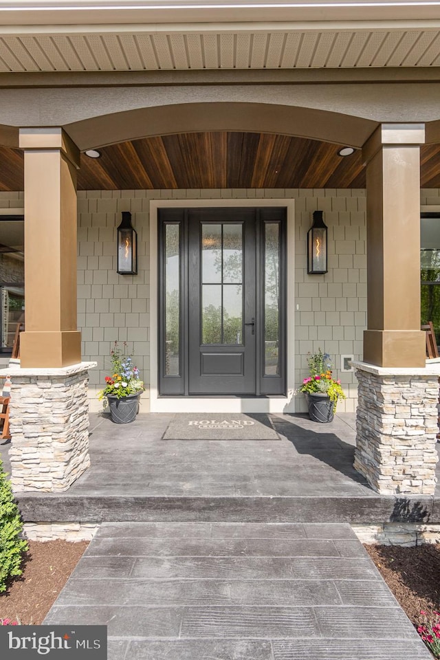 doorway to property featuring covered porch