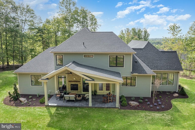 rear view of property with a patio and a yard