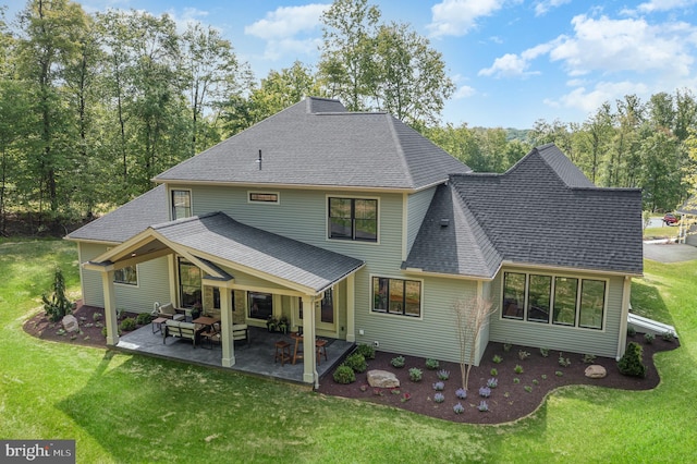 back of property featuring a yard and a patio area