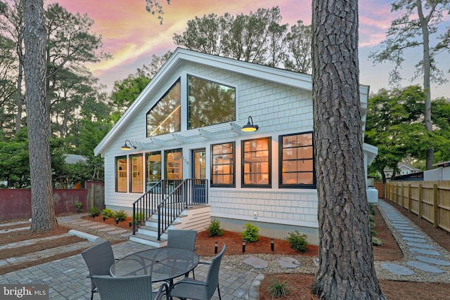 back house at dusk with a patio