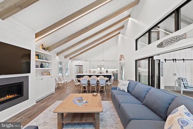 living room with beamed ceiling, dark hardwood / wood-style floors, and high vaulted ceiling