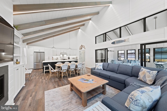 living room with beamed ceiling, dark wood-type flooring, and high vaulted ceiling