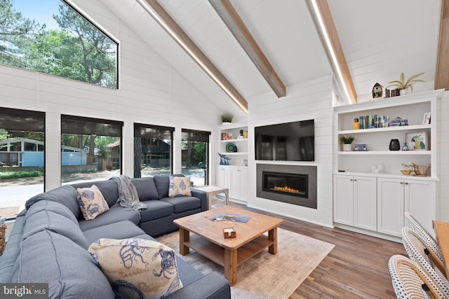 living room with beam ceiling, dark hardwood / wood-style flooring, and high vaulted ceiling