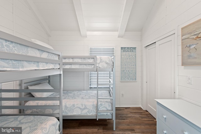 bedroom featuring vaulted ceiling with beams, a closet, and dark hardwood / wood-style flooring