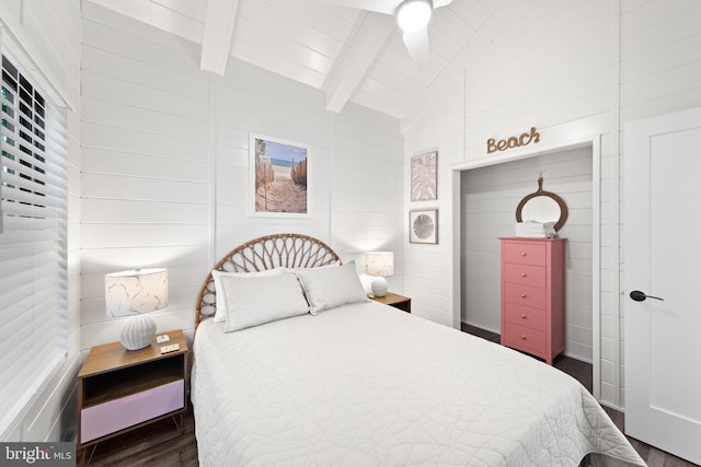 bedroom featuring vaulted ceiling with beams and dark hardwood / wood-style floors