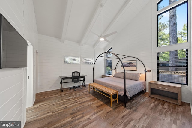 bedroom with beamed ceiling, wooden walls, hardwood / wood-style floors, and high vaulted ceiling