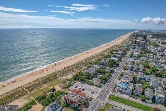 drone / aerial view featuring a water view and a beach view