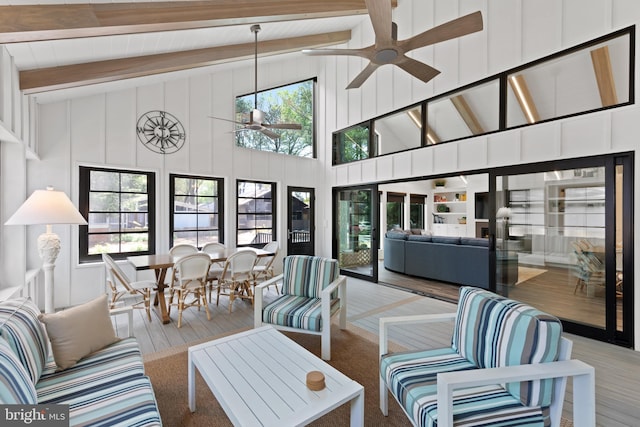 interior space featuring beam ceiling, hardwood / wood-style floors, ceiling fan, and high vaulted ceiling