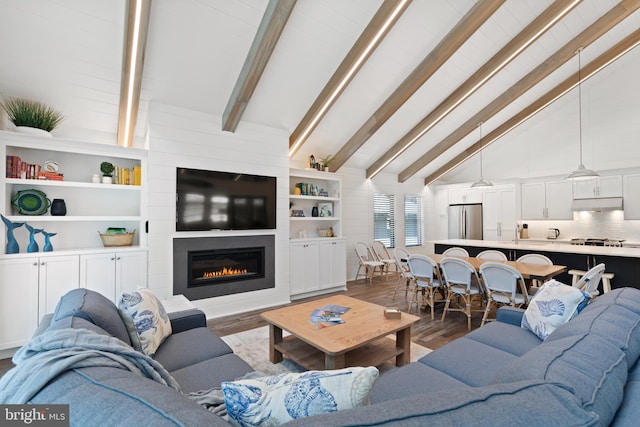 living room with a fireplace, beam ceiling, dark wood-type flooring, and high vaulted ceiling