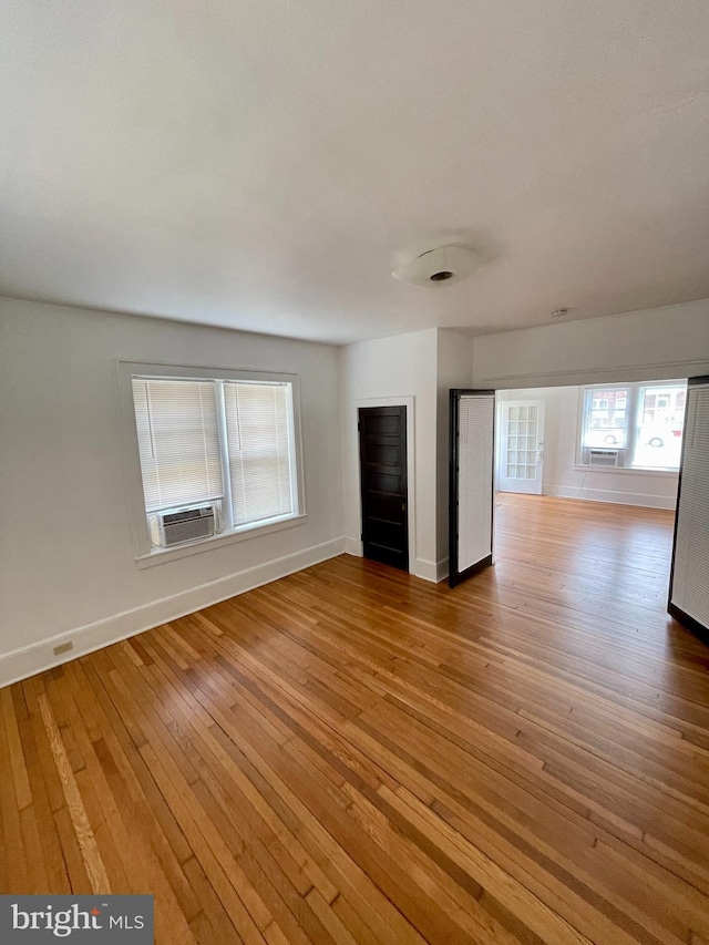 unfurnished living room featuring hardwood / wood-style flooring