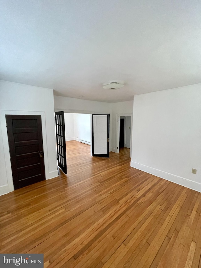 spare room featuring light hardwood / wood-style floors