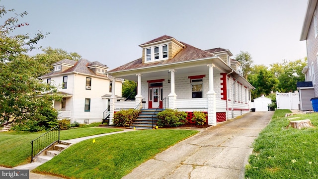 bungalow-style home with a front lawn and a porch