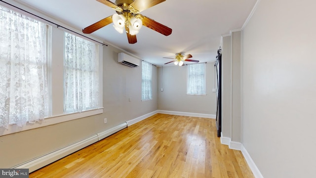 spare room featuring light hardwood / wood-style floors, a baseboard heating unit, an AC wall unit, ceiling fan, and ornamental molding