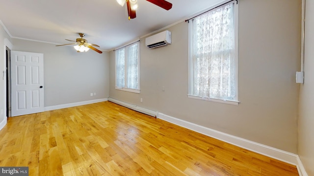 empty room featuring ceiling fan, a baseboard heating unit, and light wood-type flooring