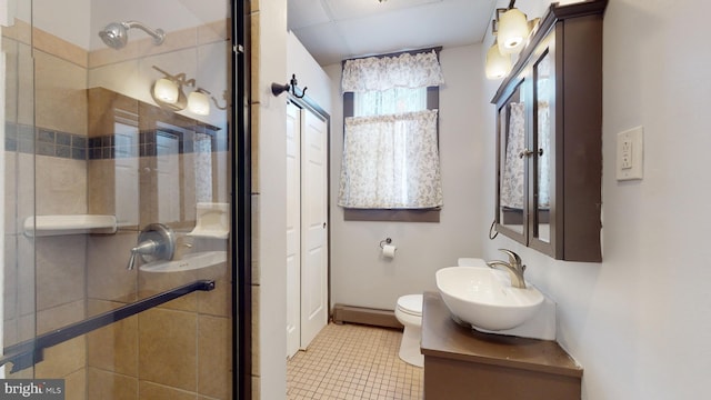 bathroom featuring tile floors, toilet, vanity, and a baseboard heating unit