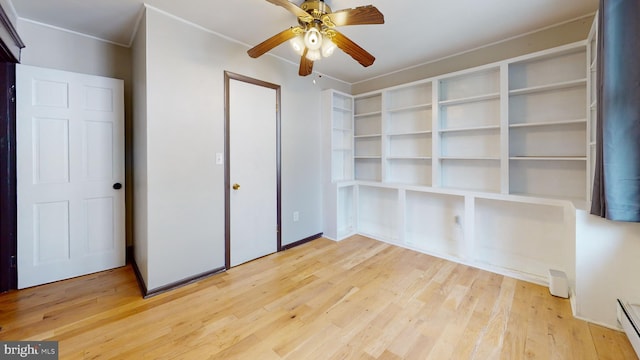 spare room featuring light hardwood / wood-style floors, ceiling fan, and baseboard heating