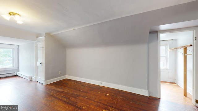 bonus room featuring vaulted ceiling and dark hardwood / wood-style flooring