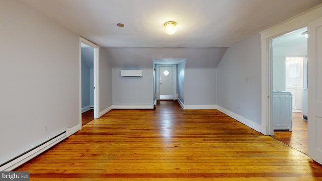 bonus room with an AC wall unit, baseboard heating, lofted ceiling, and light hardwood / wood-style floors