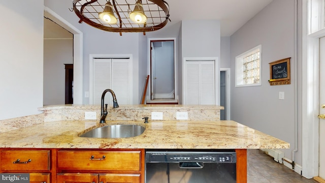 kitchen with light stone counters, a chandelier, light tile floors, dishwasher, and sink