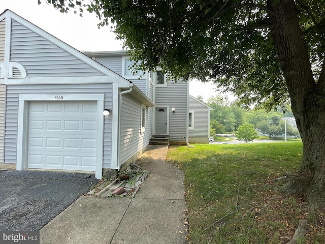 view of side of home featuring entry steps and a yard