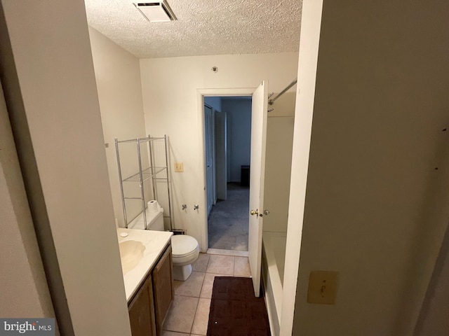 bathroom featuring visible vents, vanity, toilet, and a textured ceiling