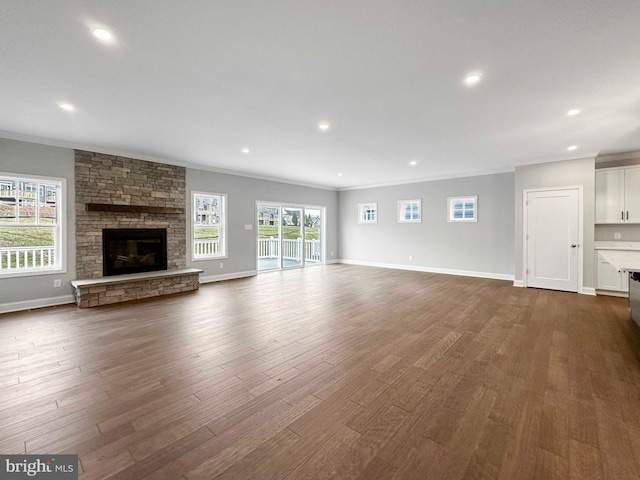 unfurnished living room with crown molding, dark hardwood / wood-style flooring, and a fireplace