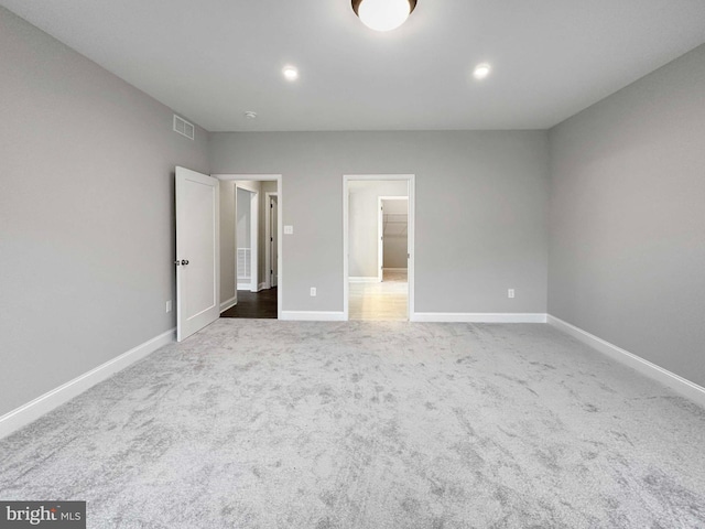 unfurnished room featuring dark colored carpet