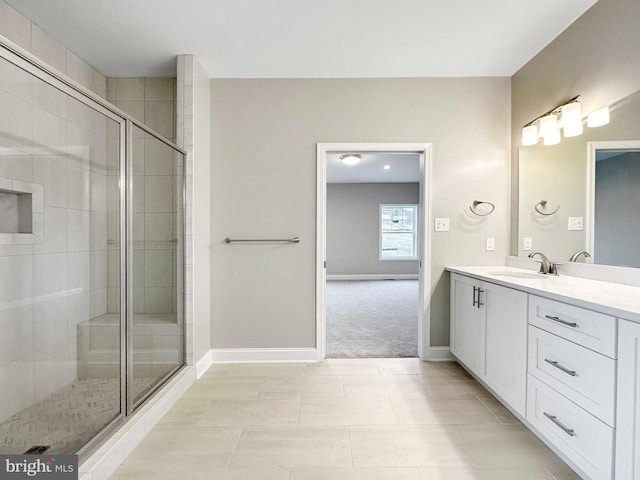 bathroom with tile floors, vanity, and an enclosed shower