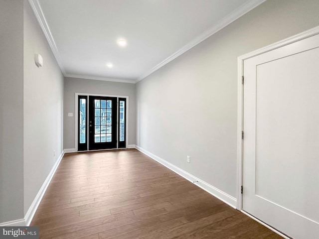 empty room with dark hardwood / wood-style flooring and ornamental molding