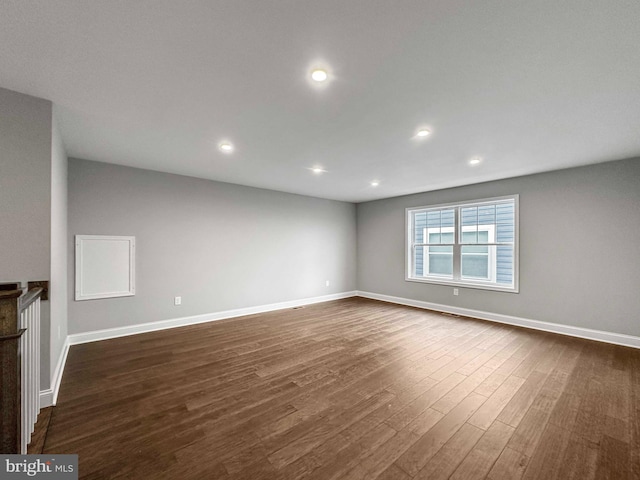 unfurnished room featuring dark hardwood / wood-style flooring