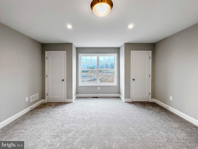 unfurnished bedroom with light colored carpet