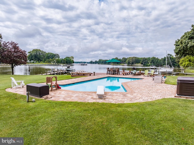 view of swimming pool with a water view, a yard, and a patio