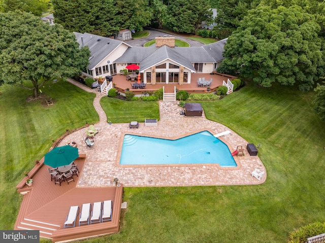 view of swimming pool with a patio area, french doors, and a yard