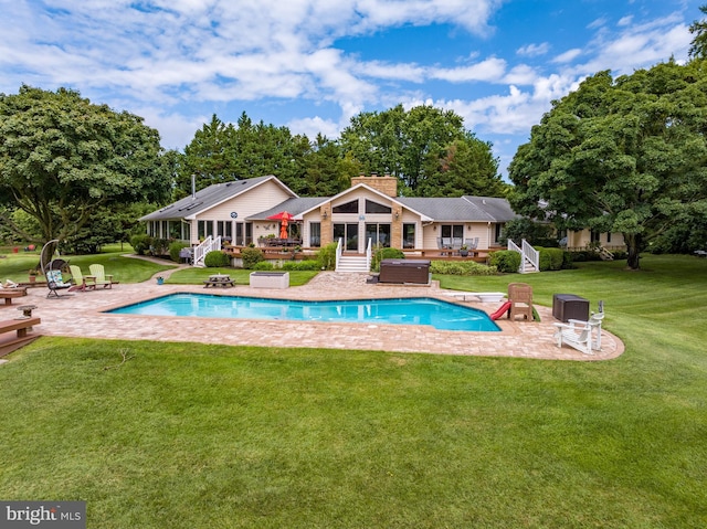 view of pool with a patio and a yard