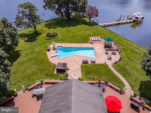 view of swimming pool featuring a deck with water view, a boat dock, a yard, a fire pit, and a patio area