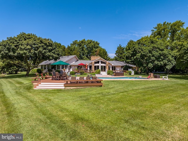 rear view of house featuring a lawn