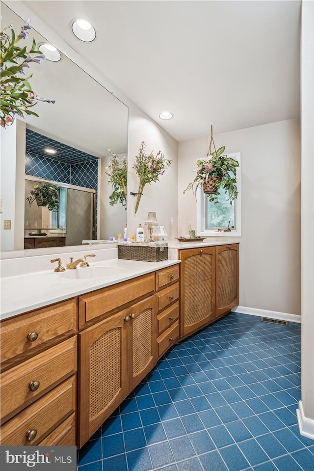 bathroom with tile flooring and vanity