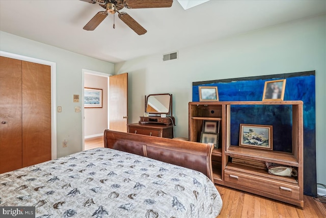 bedroom featuring a closet, ceiling fan, and light hardwood / wood-style flooring