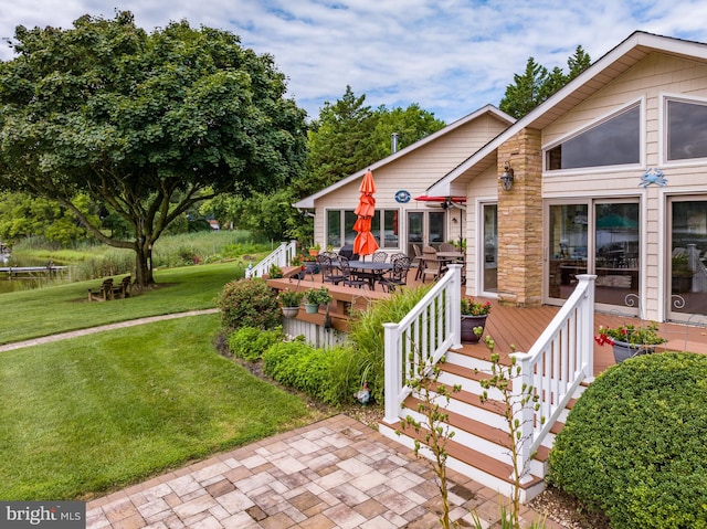 bungalow with a deck and a front lawn