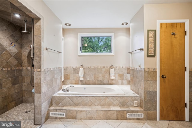 bathroom with tile floors and separate shower and tub