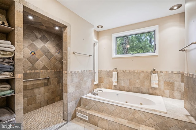 bathroom with tile flooring and separate shower and tub