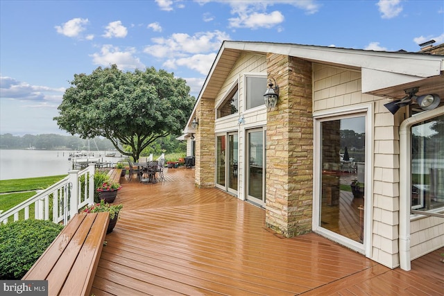 wooden terrace featuring a water view