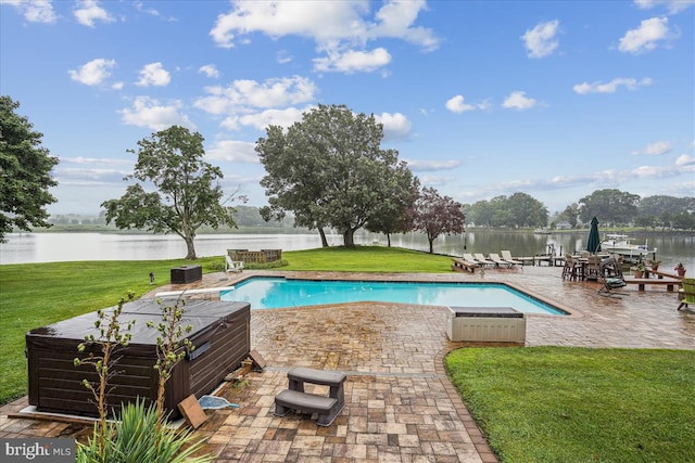 view of pool featuring a water view, a lawn, and a patio