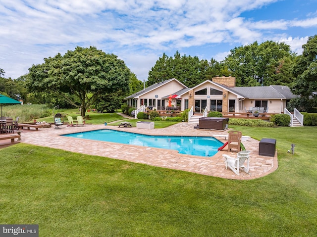 view of swimming pool with a lawn and a patio area