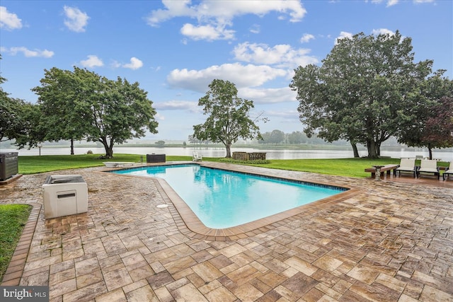 view of pool featuring a patio and a yard