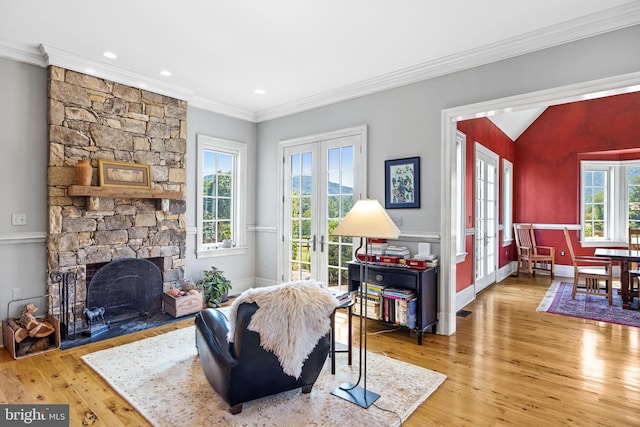 living room featuring a fireplace, french doors, vaulted ceiling, and hardwood / wood-style flooring