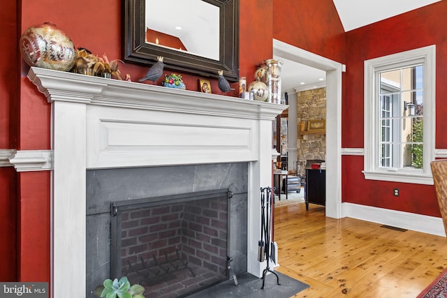 interior details with a fireplace and hardwood / wood-style floors